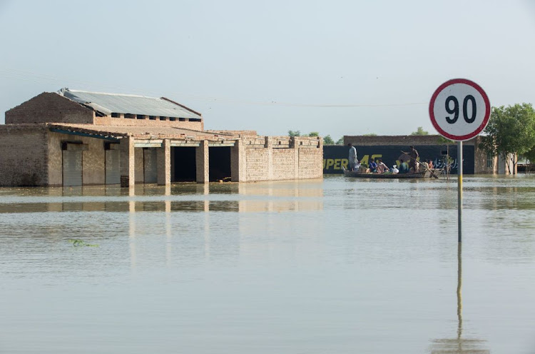 A private rescue boat carries evacuees through floodwater at Goth Muhammad Yusuf Naich in Dadu district, Sindh province, Pakistan, on September 1 2022. Picture: BLOOMBERG/ASIM HAFEEZ