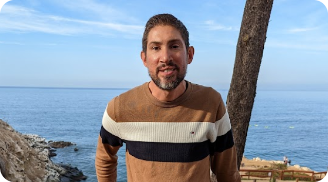 Bill posing in front of the ocean