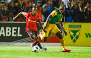 Siyabonga Dube of Lamontville Golden Arrows challenges Paseka Mako of Pirates during the Absa Premiership 2019/20 football match between Golden Arrows and Orlando Pirates at Sugar Ray Xulu Stadium on 07 March 2020.