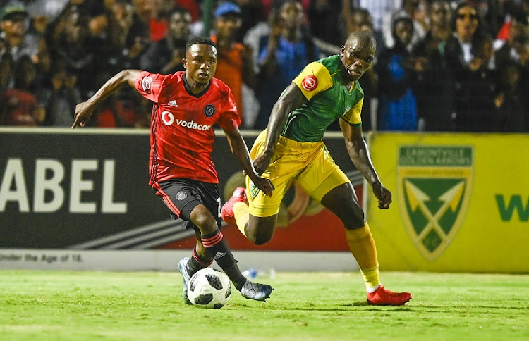 Siyabonga Dube of Lamontville Golden Arrows challenges Paseka Mako of Pirates during the Absa Premiership 2019/20 football match between Golden Arrows and Orlando Pirates at Sugar Ray Xulu Stadium on 07 March 2020.