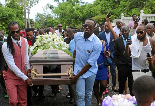 Jamaica's Olympic champion Usain Bolt, right, helps carry the coffin of high jump star Germaine Mason, who died in a motorbike crash, to the cemetery in Grange Hill, Jamaica, on Sunday.