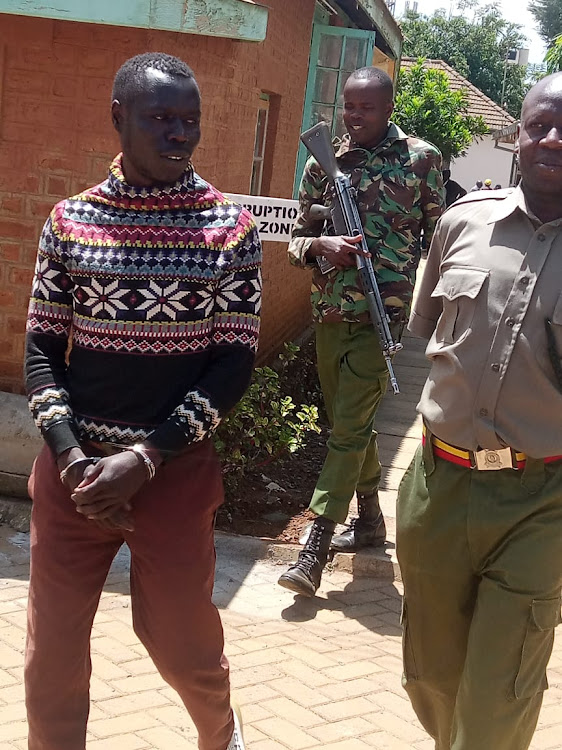 Edwin Mule is escorted to jail after being sentenced by a court in Eldoret on November 14,