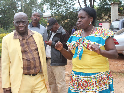 Phillip Njuguna, Chairman of Kandara residents association with another resident at Murang'a law courts.