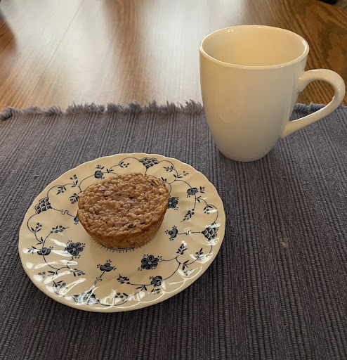 Oatmeal cup with Raspberry Pie Filling and a cup of tea.