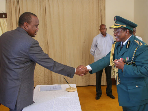 President Uhuru Kenyatta congratulates new National Youth Service director general, Richard Ndubai, after his swearing-in at State House in Mombasa, January 19, 2016. Photo/REUTERS