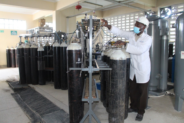 John Obiero, a plant operator, monitors the filling of oxygen into cylinders at Hewatele Oxygen Plant, Mama Lucy Hospital, Nairobi, on April 12