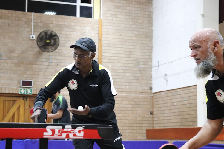 Aryan A's Thiagasen Pather serves, with doubles partner Shahied Abrahams ready to attack.