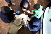 Some of Recovered children who were rescued from an illegal initiation school in Dennilton, Limpopo, share food brought by their parents. 