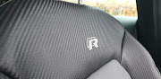 Sports seats with carbon-fibre weave and an ‘R’ logo add to the racy interior vibes. Picture: DENIS DROPPA