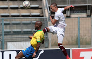 Ruzaigh Gamildien of Swallows cross blocked by Mosa Lebusa of Mamelodi Sundowns during the DStv Premiership match between Mamelodi Sundowns and Swallows FC at Lucas Masterpieces Moripe Stadium on January 23, 2021 in Pretoria, South Africa.