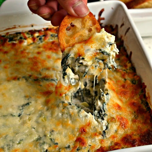 A super easy delectable cheesy spinach and artichoke party dip prepped in less than ten minutes. Serve with carrot sticks, cucumber rounds, pretzel crisps, bagel chips or Easy Crostini.