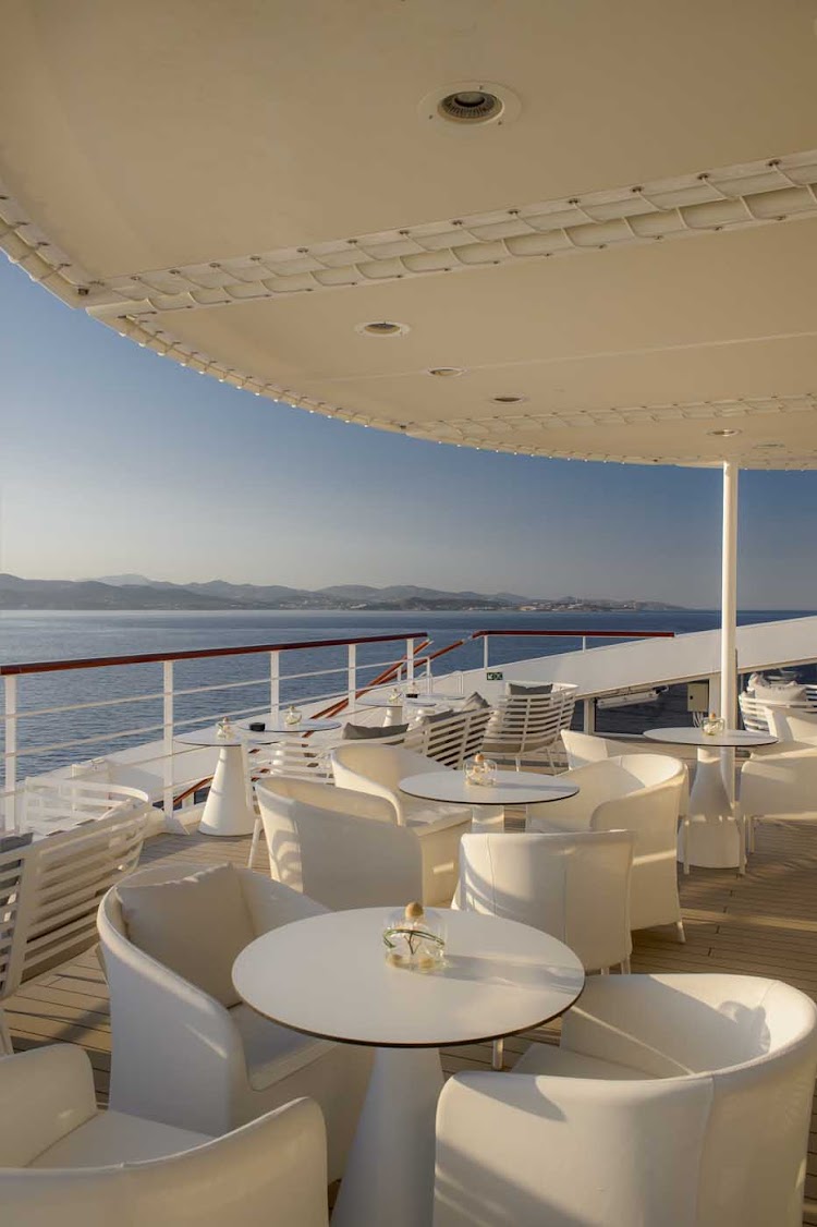 Enjoy refreshing sea and land views during al fresco dining on your Ponant cruise.