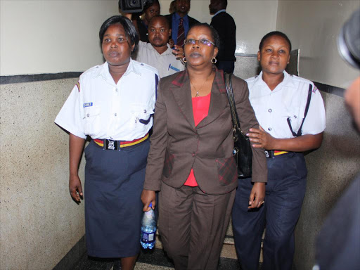 Former City Council of Nairobi NCC legal officer Mary Ngethe is led to the cells after she pleaded not guilty of defrauding the public over the cemetery saga.Jeptum Chesiyna