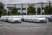 Tesla vehicles are parked at the company's assembly plant in Fremont, California, US. Tesla on Wednesday announced that it will be slashing the prices of its cars sold in America and China. 