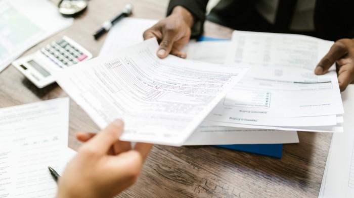 Lawyer handing client a legal form