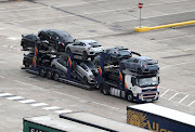 A lorry carrying new cars arrives to cross the Channel at the Port of Dover in Kent.