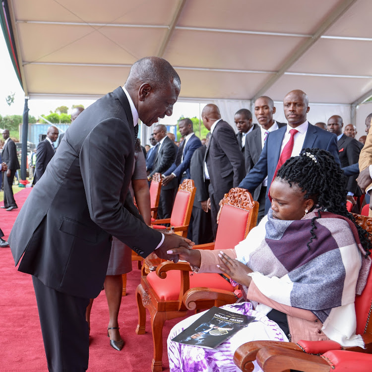 President William Ruto with Kelvin Kiptum's widow Asenath Rotich during the burial service of Kiptum in Elgeyo Marakwet on February 23, 2024