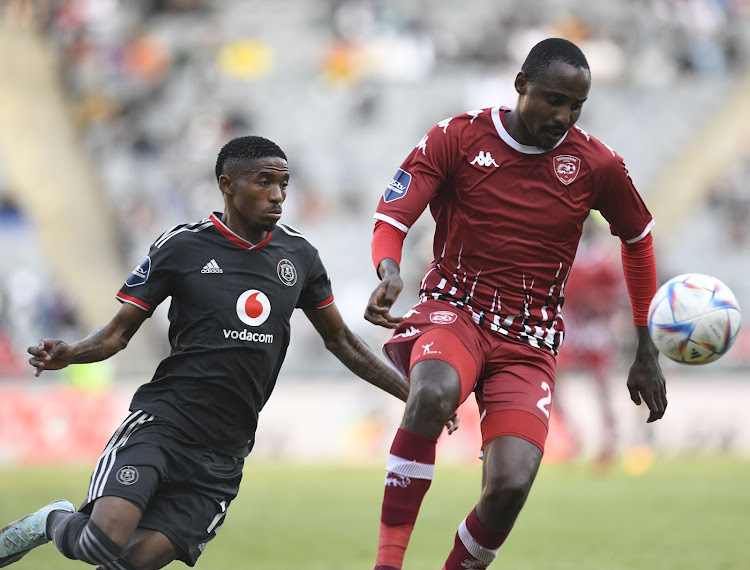 Katlego Mkhabela of Sekhukhune United is challenged by Monnapule Saleng of Orlando Pirates during their DStv Premiership match at Orlando Stadium.