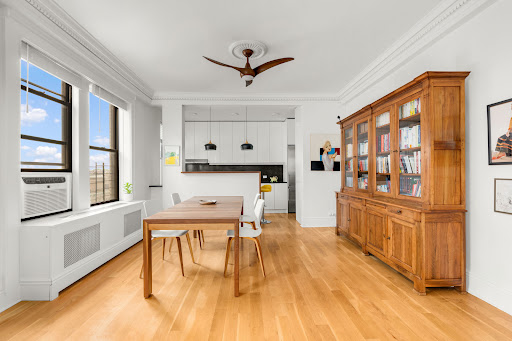 Dining room with wooden sideboard in this luxury property for sale in New York ($899,000)