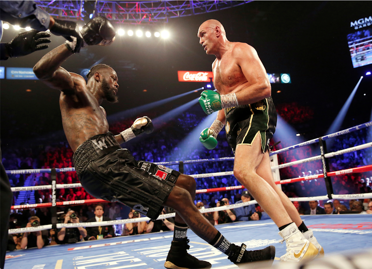 Tyson Fury knocks down Deontay Wilder during their fight