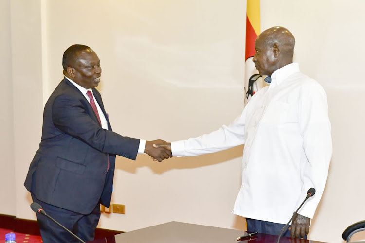 Great Lake Region Private Sector Forum chairman Richard Ngatia and Ugandan President Yoweri Museveni after he paid the President a courtesy call atState House in Entebe, Uganda on Friday.