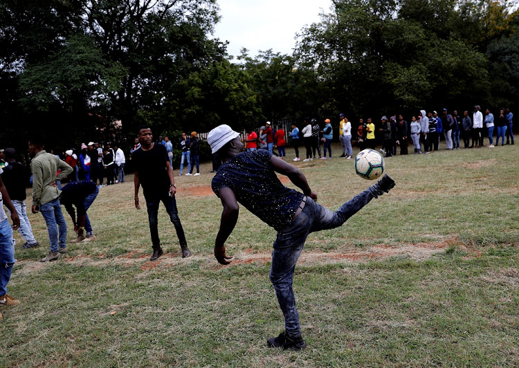 Voters play soccer as after ballot paper shortages at the Pretoria West High School resulted in long queues and long waits on Wednesday May 8 2019.