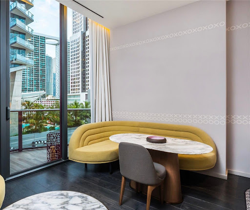 Modern living room with yellow sofa and urban view - Buy this luxury property in Miami