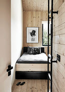 The steel ladder in this child's bedroom leads up to an additional sleeping area in the loft.