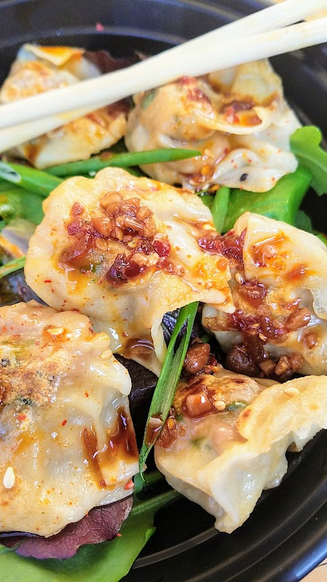 Dumpling Week 2018 - For dumpling week Mama Chow Kitchen offered a pan seared version of their wontons from their standard wonton soup, these are Pork and Shimp dumplings on a bed of baby green salad and served with a spicy dipping sauce.