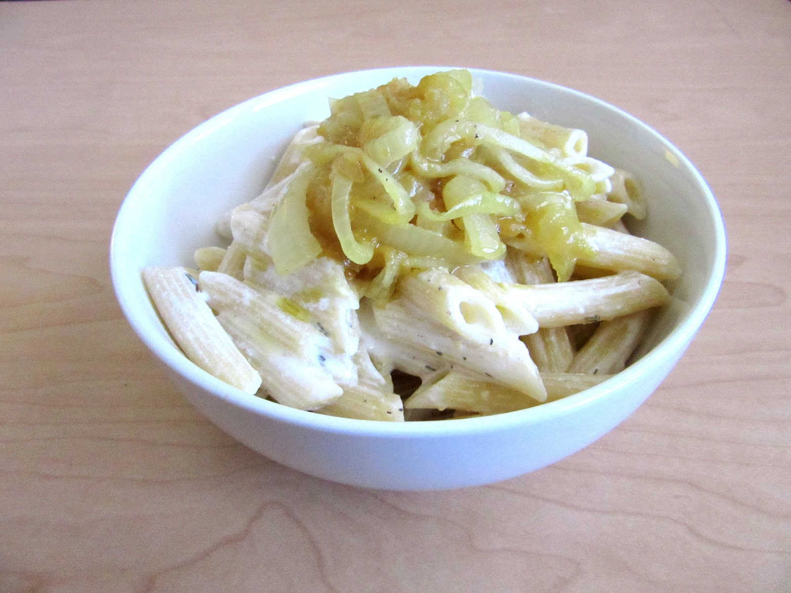 Pasta tossed in an easy, creamy yogurt sauce and topped with caramelized onions and parmigiano.