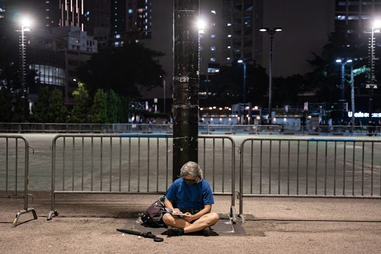 A man sits at the Victoria Park during a solitary vigil ahead of the 33rd anniversary of Tiananmen Square incident on June 03, 2022 in Hong Kong, China. The government announced to seal off the main parts of Victoria Park, where people gathered for the annual June 4 vigil. Police also have warned the public not to test their determination to enforce the law on June 4, adding that even going alone could end in an arrest for unlawful assembly, if someone is deemed to be there with a common purpose to express certain views.