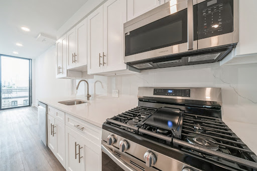 Modern kitchen with stainless steel appliances in this luxury house for rent in Journal Square ($2,950)