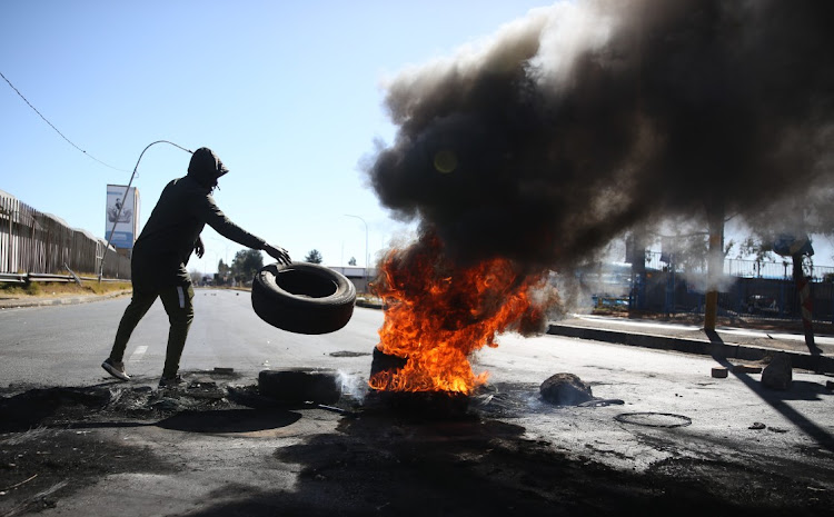 Residents of Riverlea block Main Reef Road in Johannesburg to protest against illegal miners in the area.