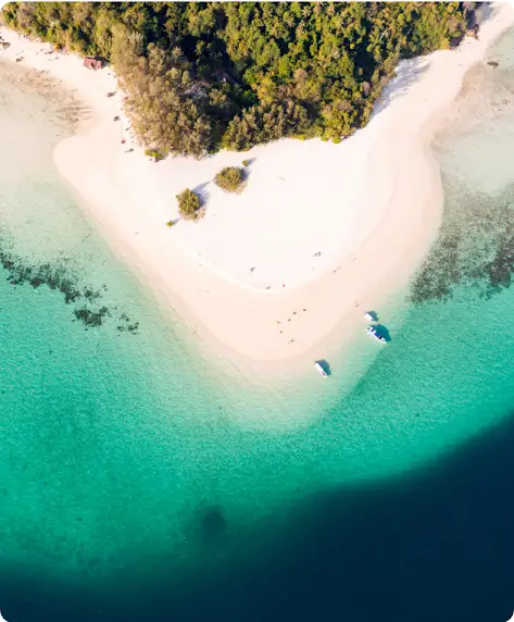 Aerial shot of a beach with turquoise water.