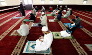 Worshippers gather to pray under the 