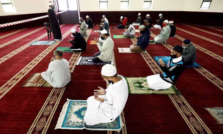 Worshippers gather to pray under the "new normal" in Cape Town.