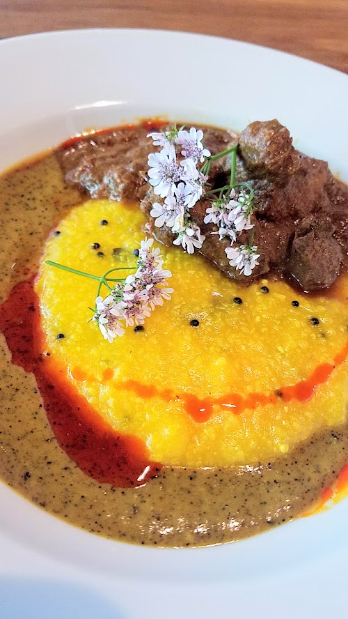 Aramsey Spiced Brunch with Ruchikala and Public Provisions: Rogan Josh, a spicy lamb curry. Here, the long simmered spicy lamb curry is combined with black cardamom, kashmiri chili oil, salt cured lemon coconut mustard polenta with yogurt, saffron, clove, nutmeg and other spices.