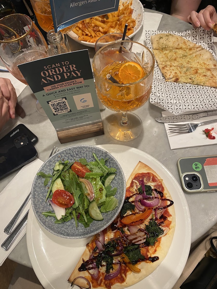 1/2 vegetariana pizza with a side salad, aperol spritz