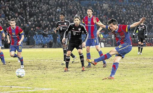 BIG BLOW: FC Basel's Valentin Stocker, right, scores the winning goal during the Champions League last-16 first-leg match against Bayern Munich on February 22. Basel could soon progress to the quarterfinals of the competition for the first time in 20 years Picture: REUTERS