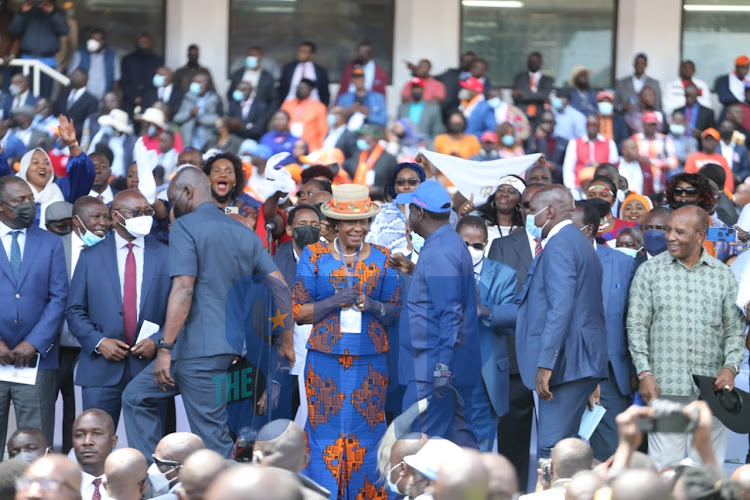 ODM Leader Raila Odinga greets Charity Ngilu when he arrived at Kasarani on December 10, 2021.