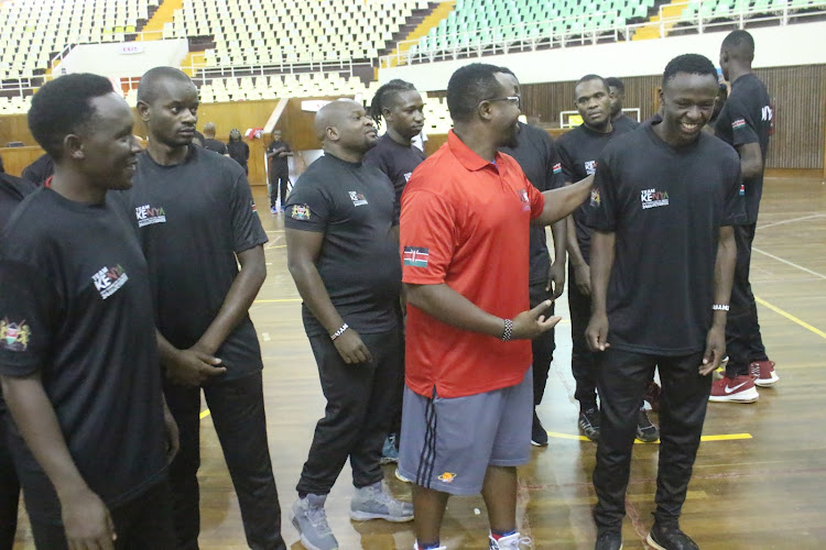 Coach Jeff Mwaniki with some of his players after a training session at Kasarani gymnasium