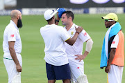 Dean Elgar of the Proteas gets attention after been hit on the head during day 3 of the 3rd Sunfoil Test match between South Africa and India at Bidvest Wanderers Stadium on January 26, 2018 in Johannesburg, South Africa.