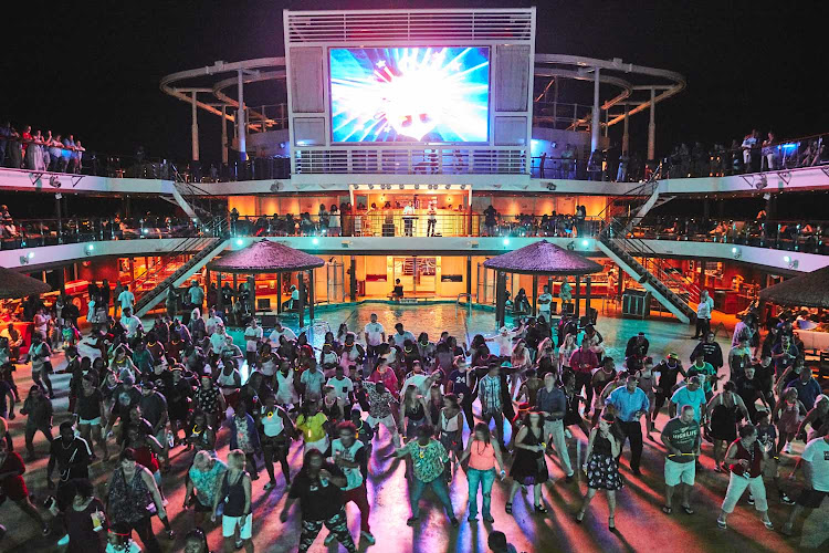 Guests celebrate during a sailaway party in Cozumel, Mexico. Join the next party on a Carnival cruise.