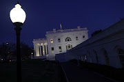 A street light illuminates an empty walkway on a day that US President Donald Trump had no public events on his schedule at the White House in Washington, US December 22, 2020.  