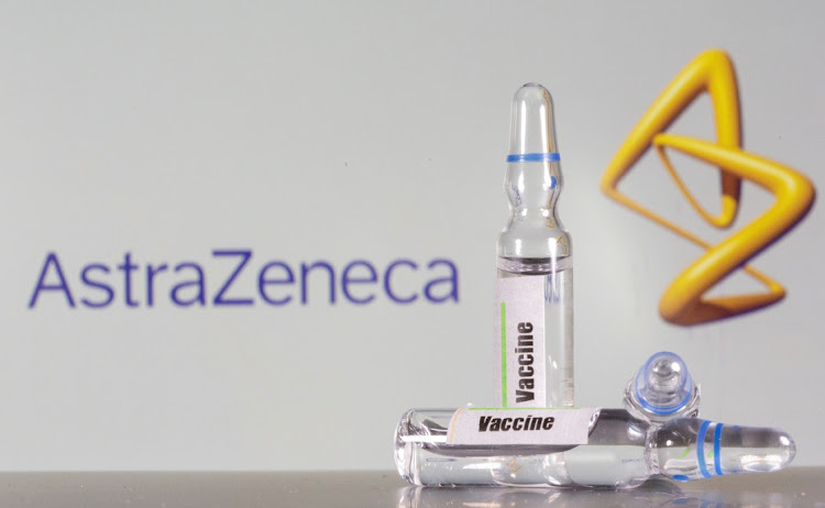 A test tube labeled with the vaccine is seen in front of AstraZeneca logo in this illustration taken, September 9, 2020. REUTERS/Dado Ruvic//File Photo