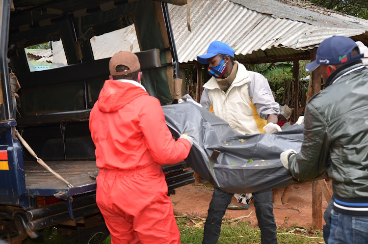 Police carry the body of Susan Mukami,26, and mother of two found murdered in a coffee farm at Karia village in Nyeri town