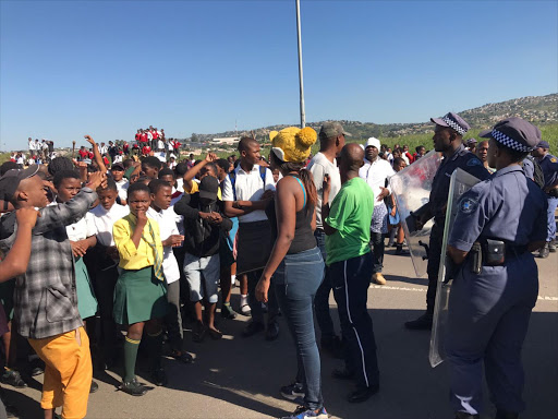 Kwamashu resident and students protesting through the streets .