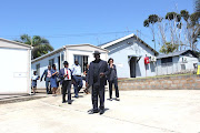 Police minister Bheki Cele arrives at the Port Edward police station on Tuesday after an officer and members of his family were killed.