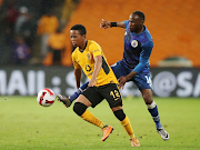 Nkosingiphile Ngcobo of Kaizer Chiefs is challenged by Supersport United's Onismor Bhasera in the DStv Premiership match at FNB Stadium in Johannesburg on April 16 2022.