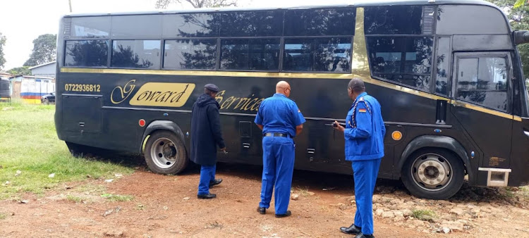 Police officers inspect the bus